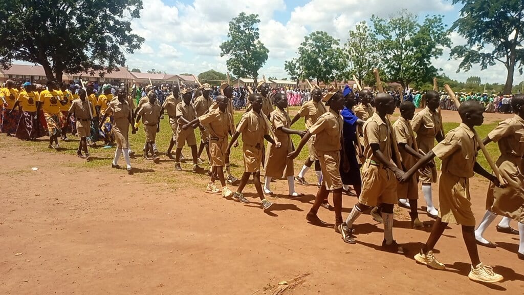 KIFA team engaging with community members gathering under a tree